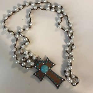 long pearl necklace with brown and teal cross